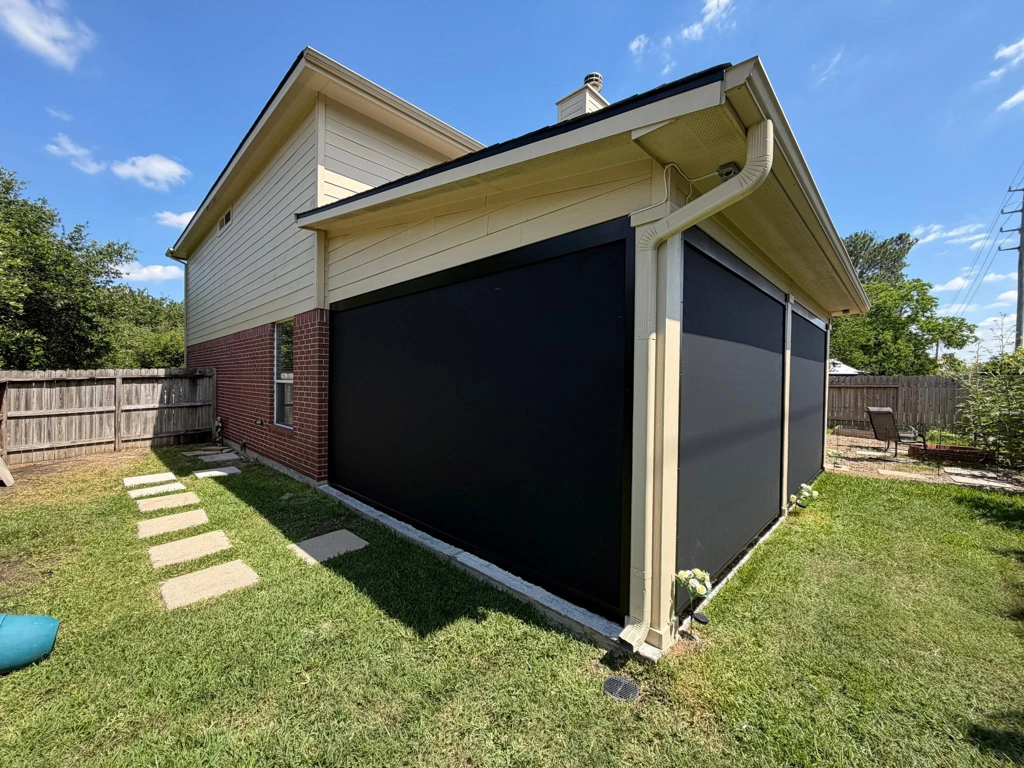 Motorized shade lowered over a Houston patio