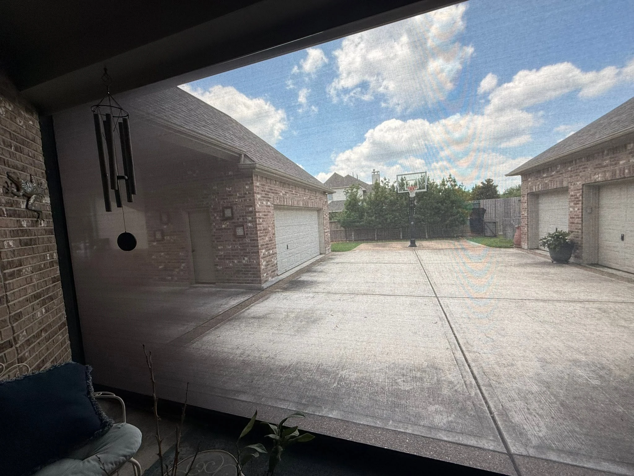 Motorized shade lowered over a Houston patio