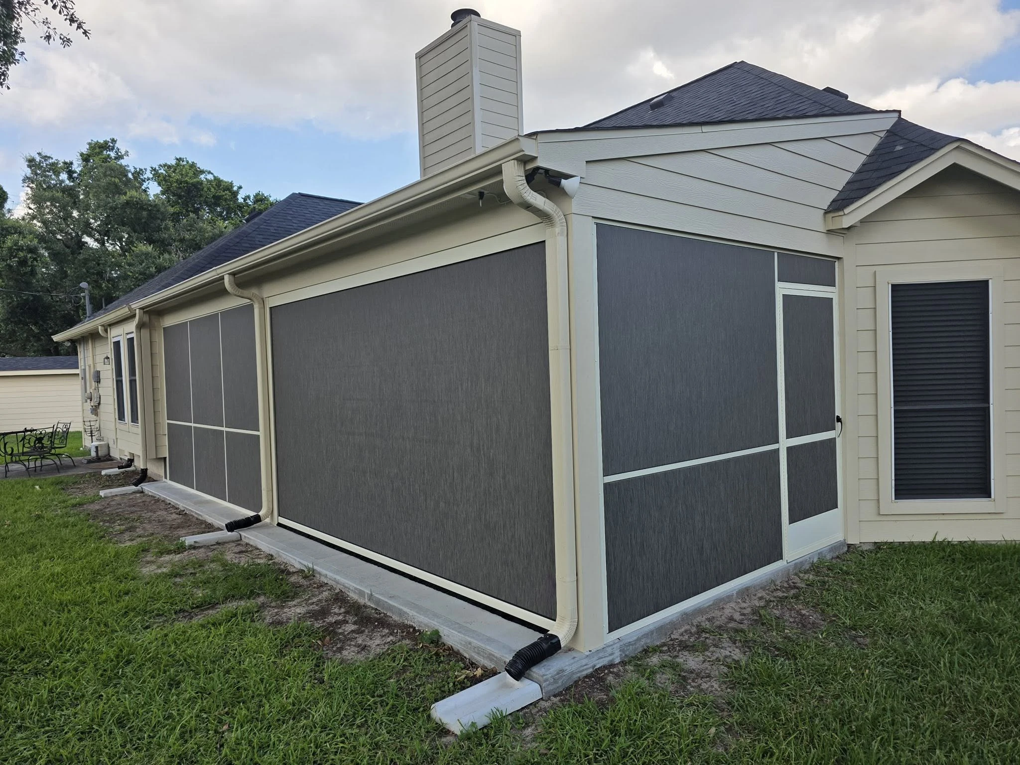 Motorized shade lowered over a Houston patio