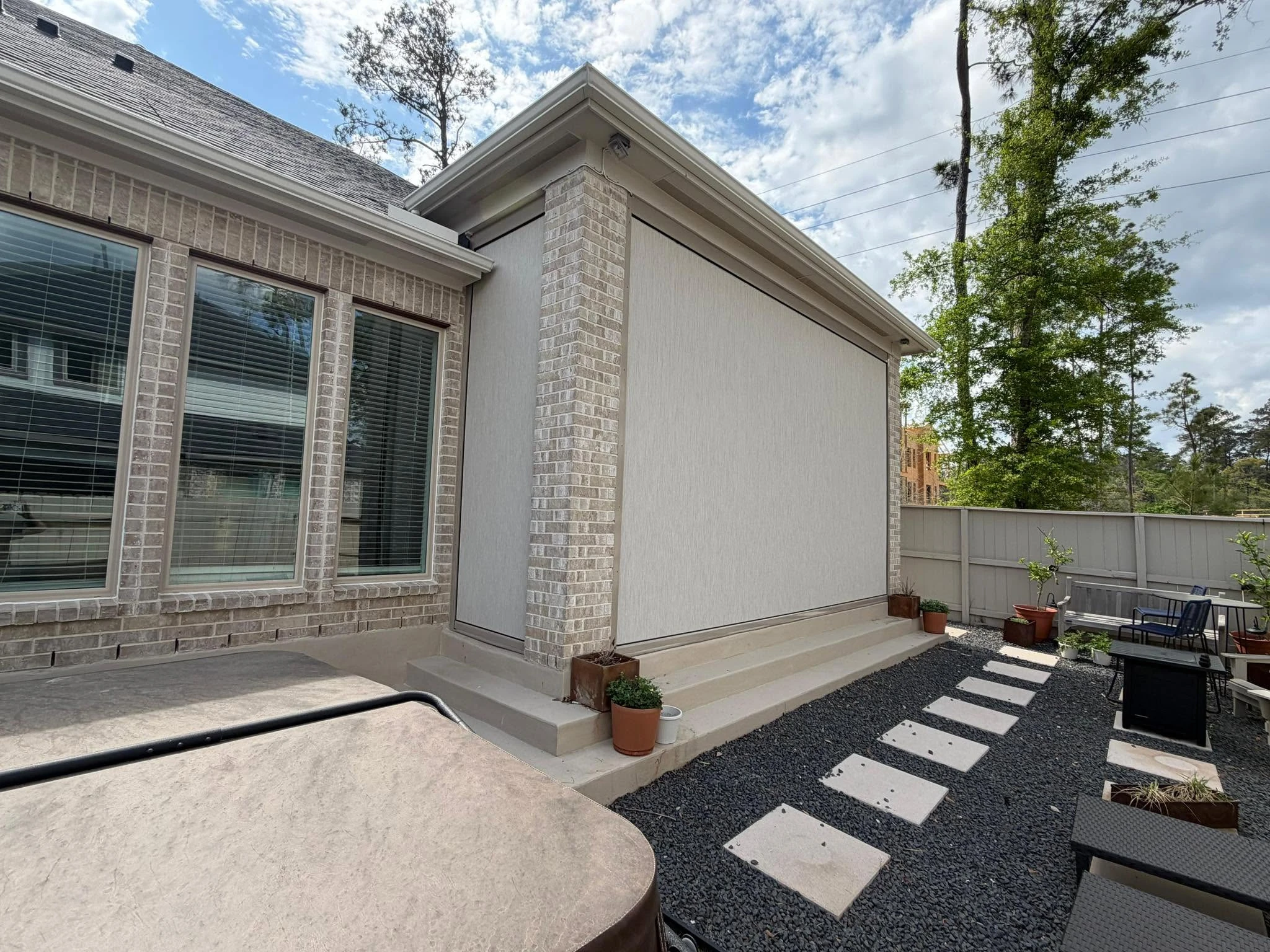 Motorized shade lowered over a Houston patio
