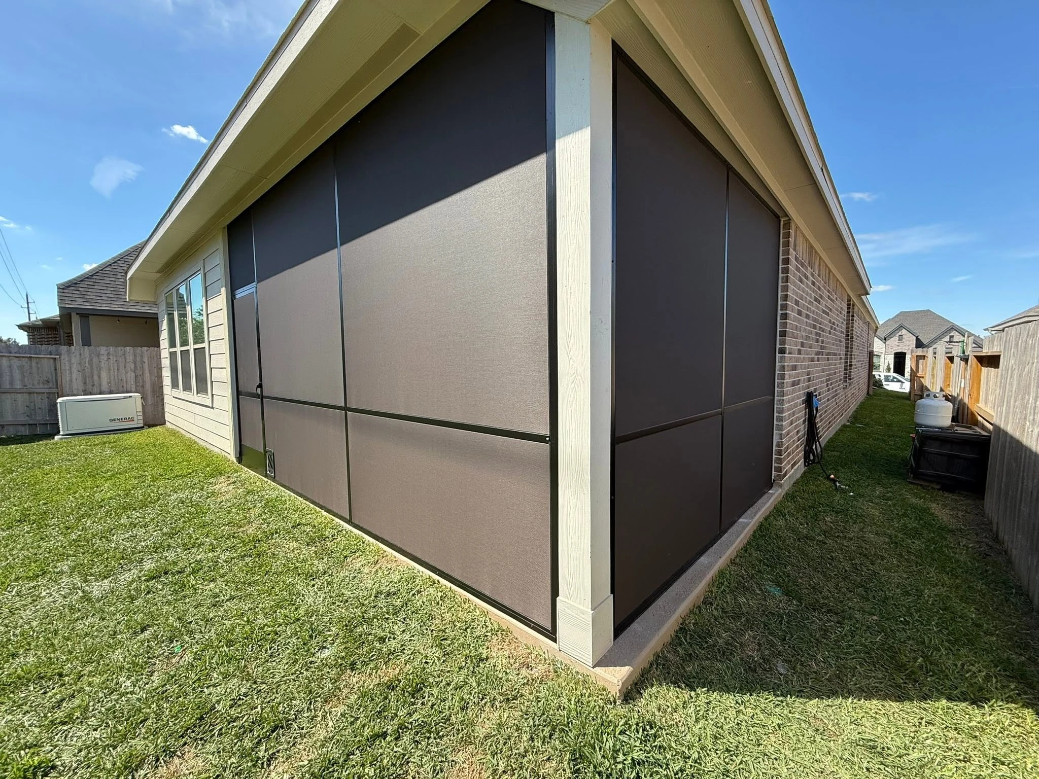 Patio shade system installed on a Houston backyard