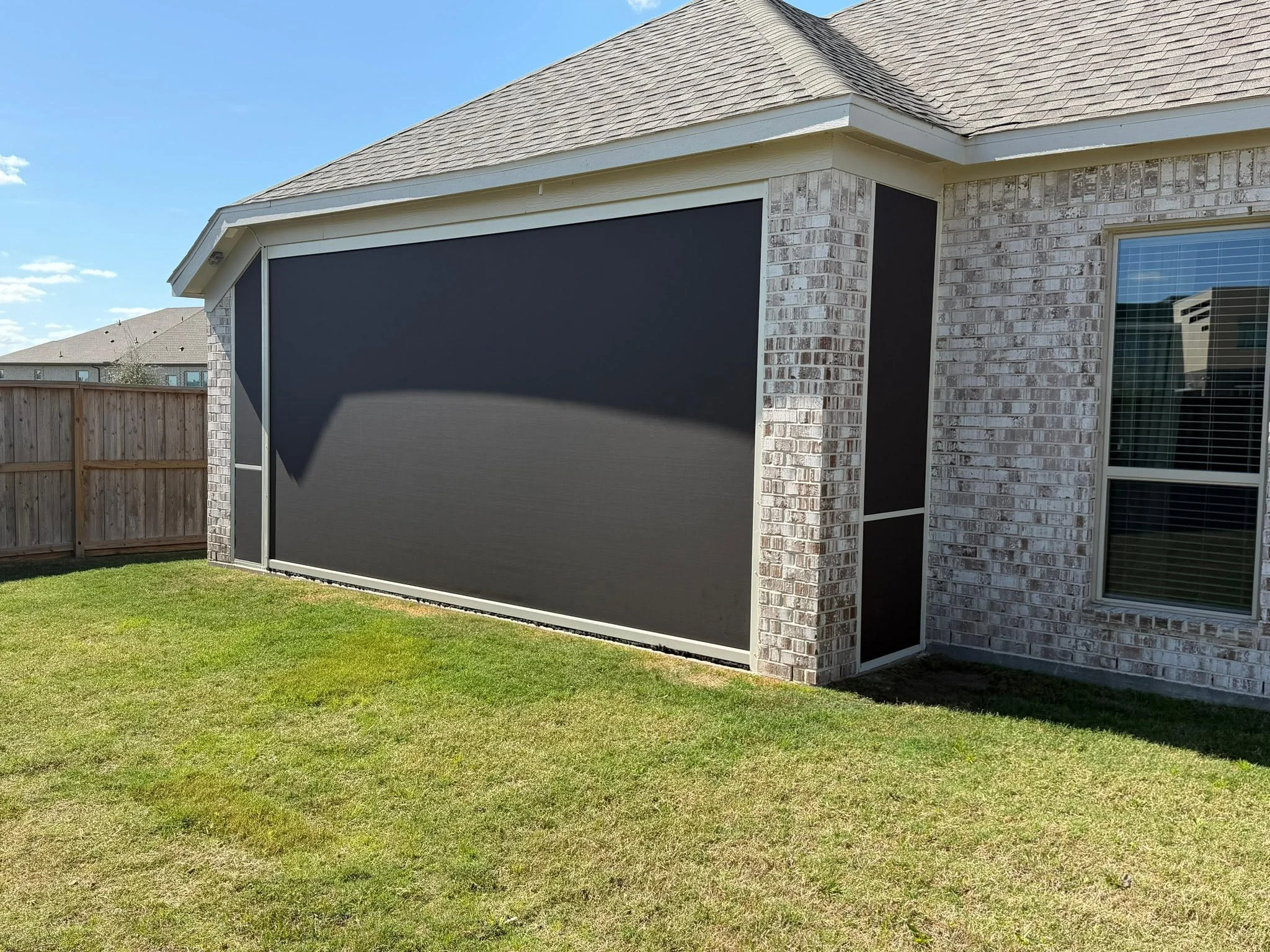 Outdoor living space shaded by a custom patio system