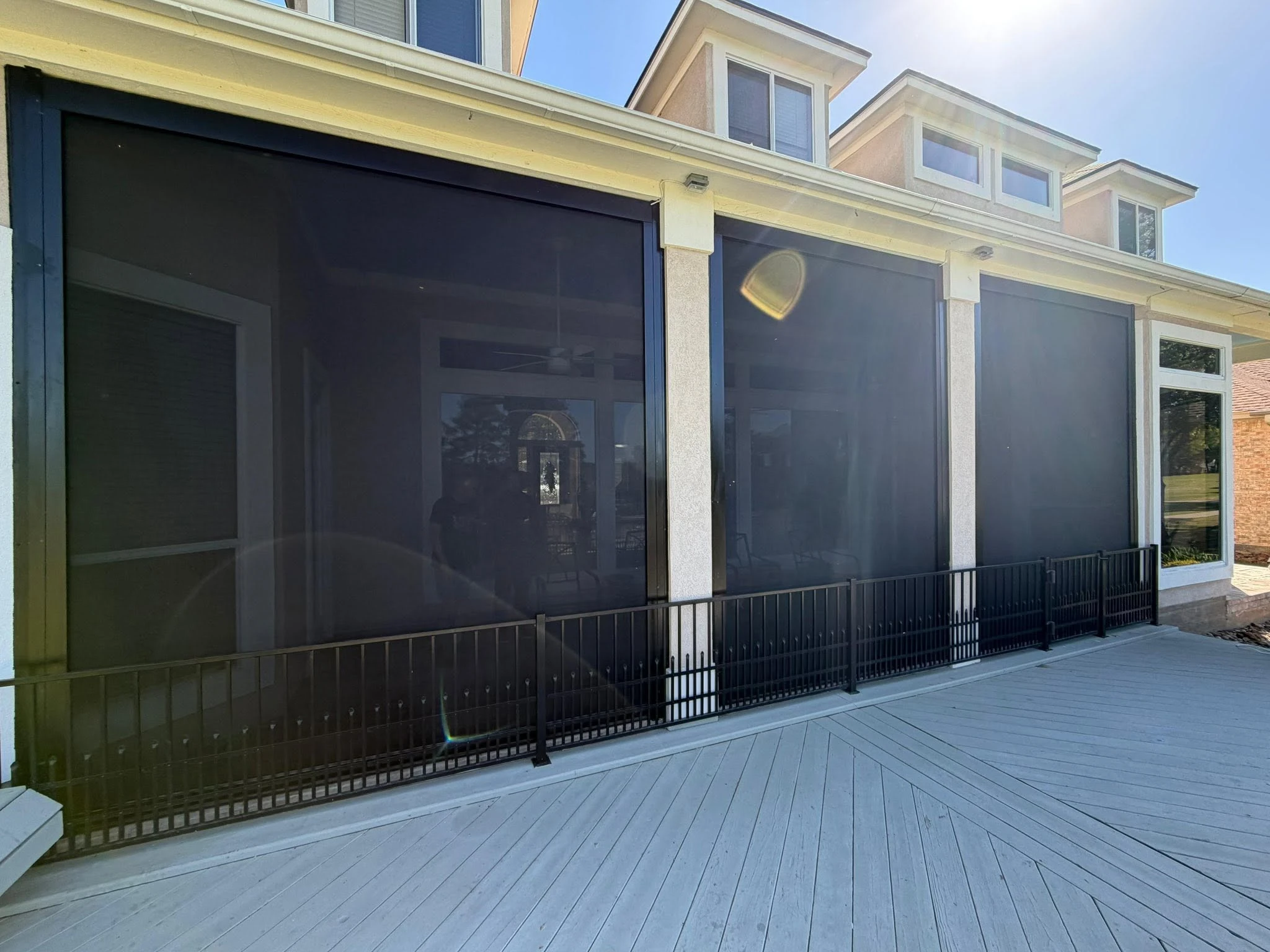 Motorized shade lowered over a Houston patio