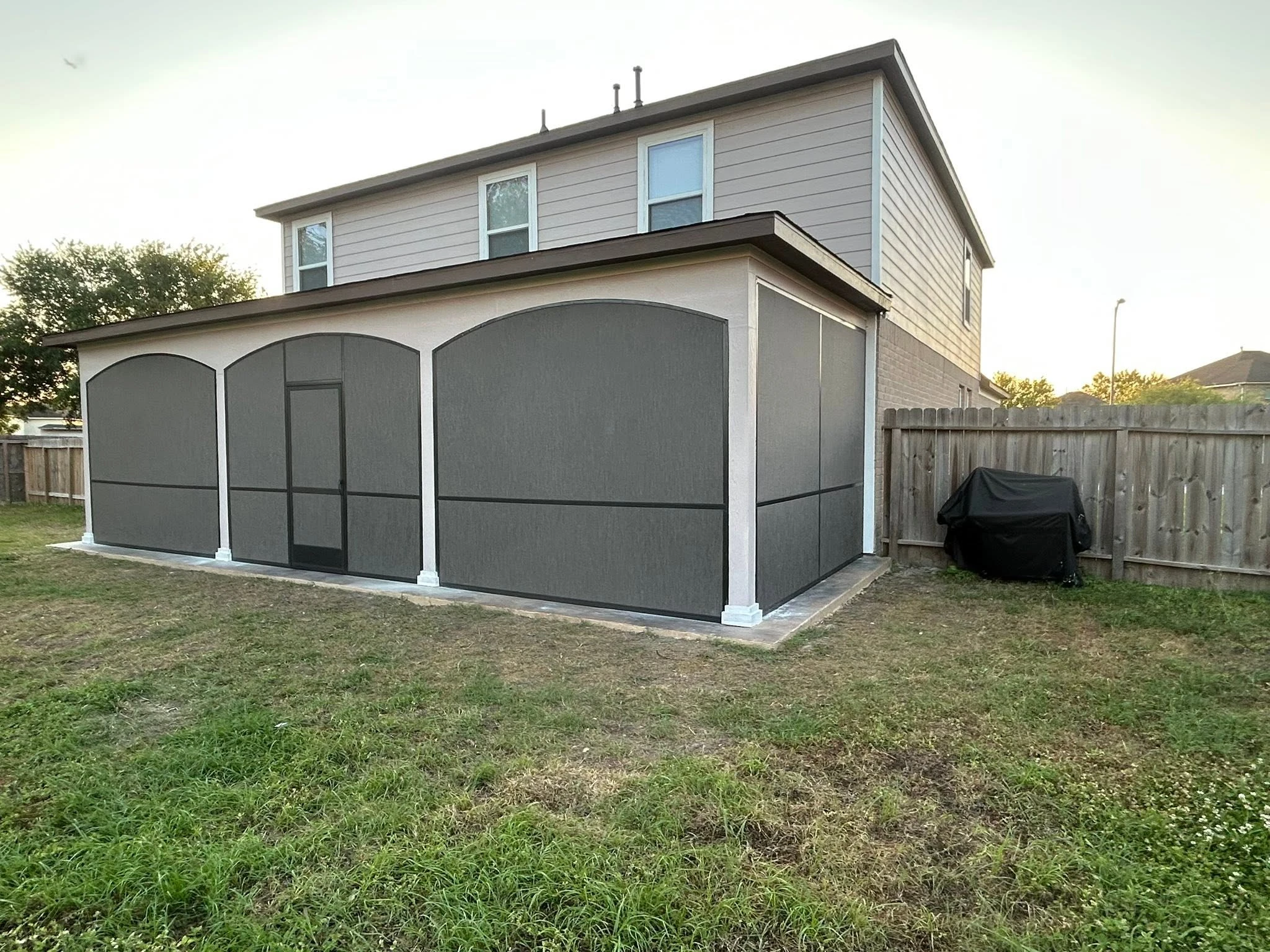 Outdoor living space shaded by a custom patio system
