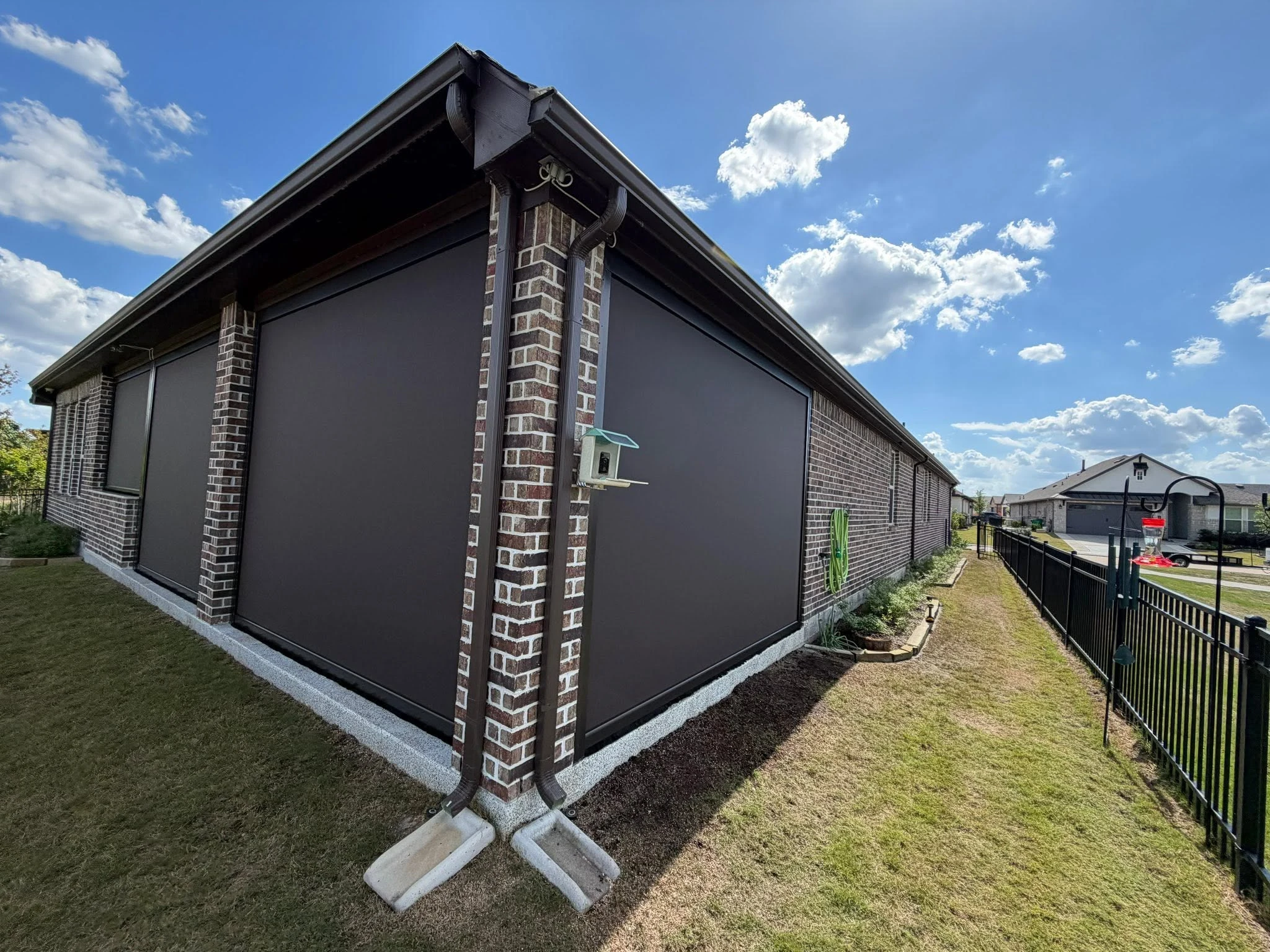 Motorized shade lowered over a Houston patio