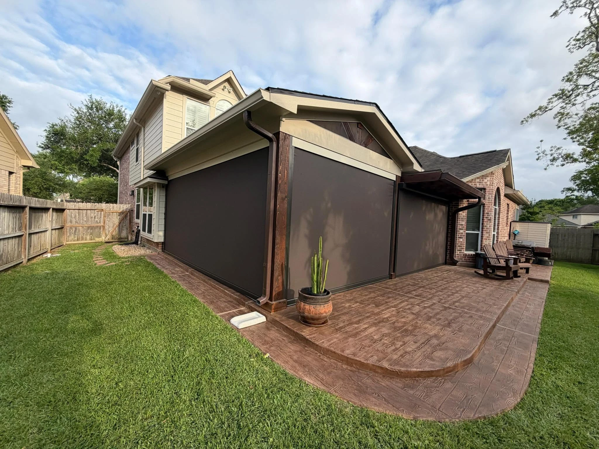 Motorized shade lowered over a Houston patio