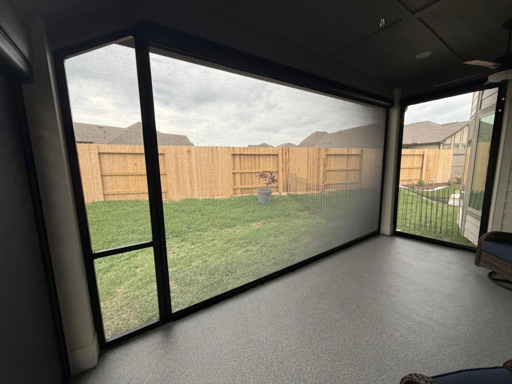 Motorized shade lowered over a Houston patio