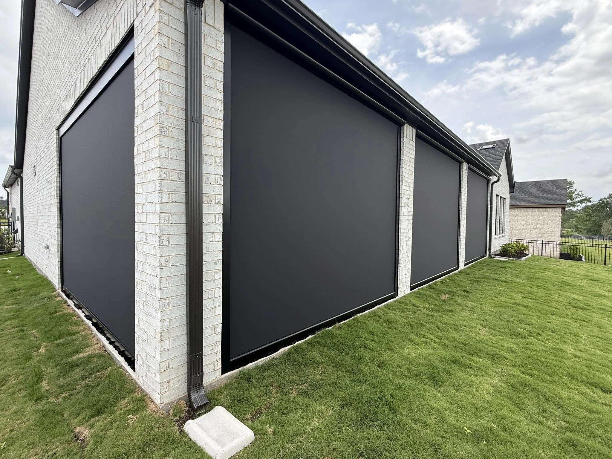 Motorized shade lowered over a Houston patio
