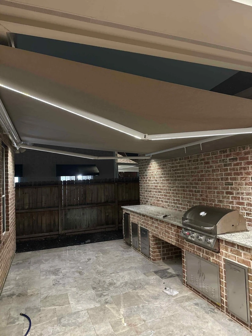 Motorized awning extended over an outdoor seating area