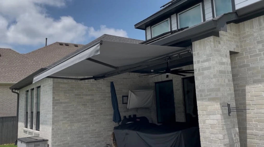 Custom motorized awning on a Houston home exterior