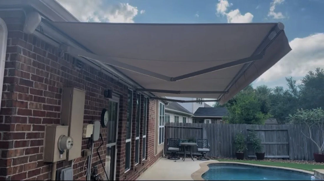Motorized retractable awning over a Houston backyard patio