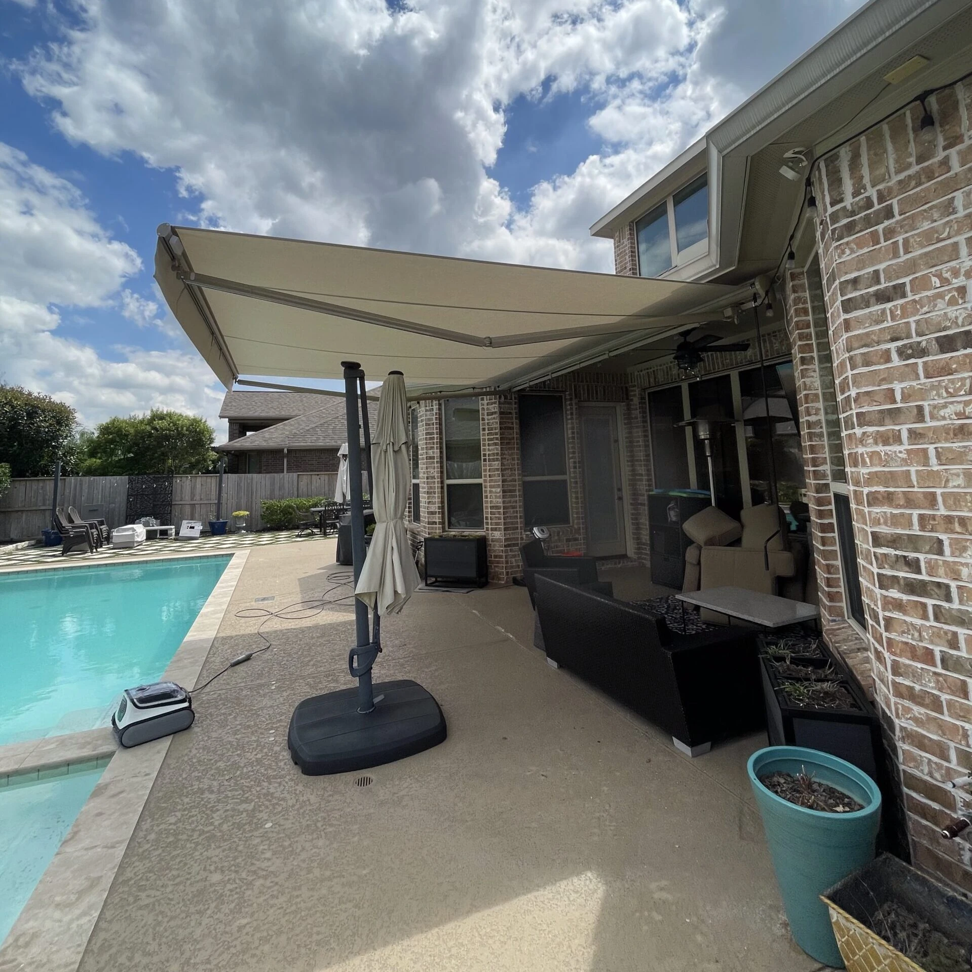 Motorized retractable awning extended over a Houston outdoor living space
