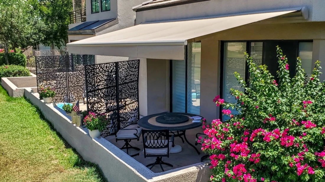 Retractable awning providing shade over a backyard deck
