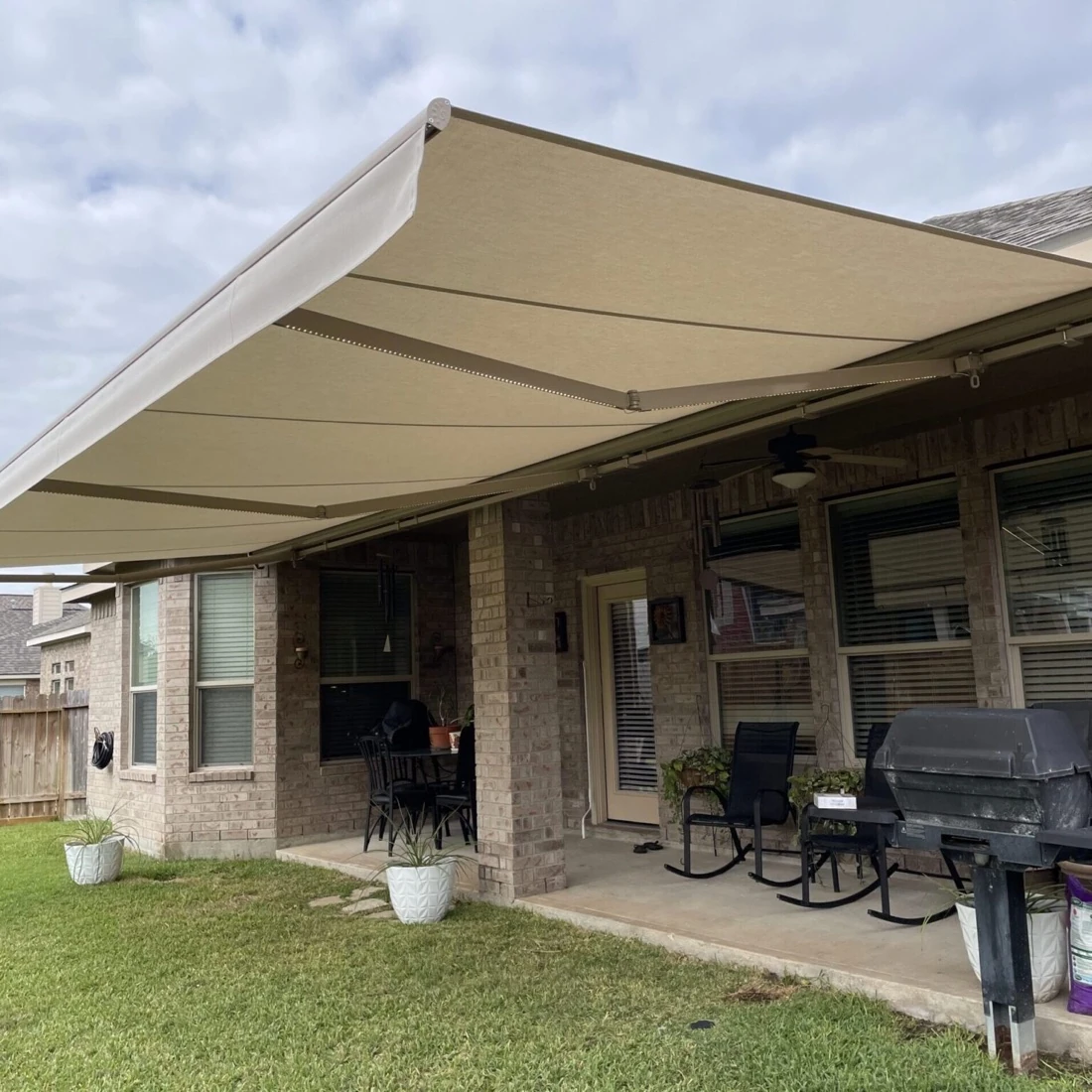 Retractable awning shading a Houston home patio