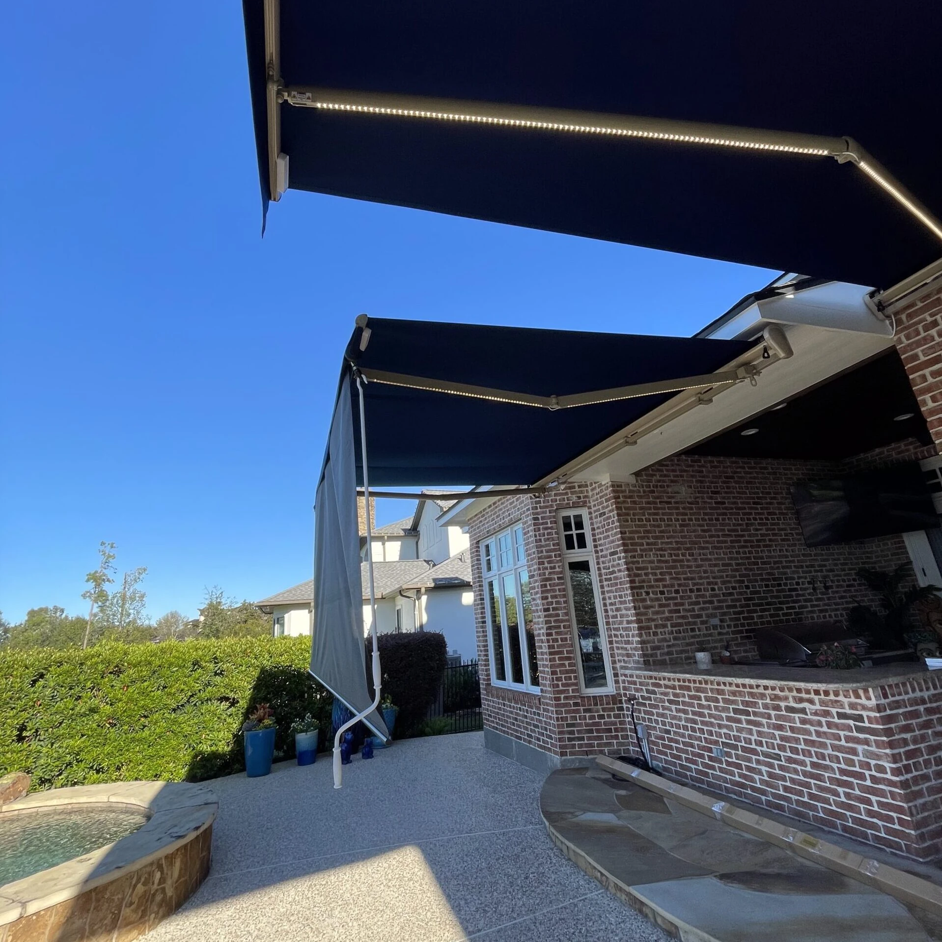 Motorized retractable awning installed on a Houston home