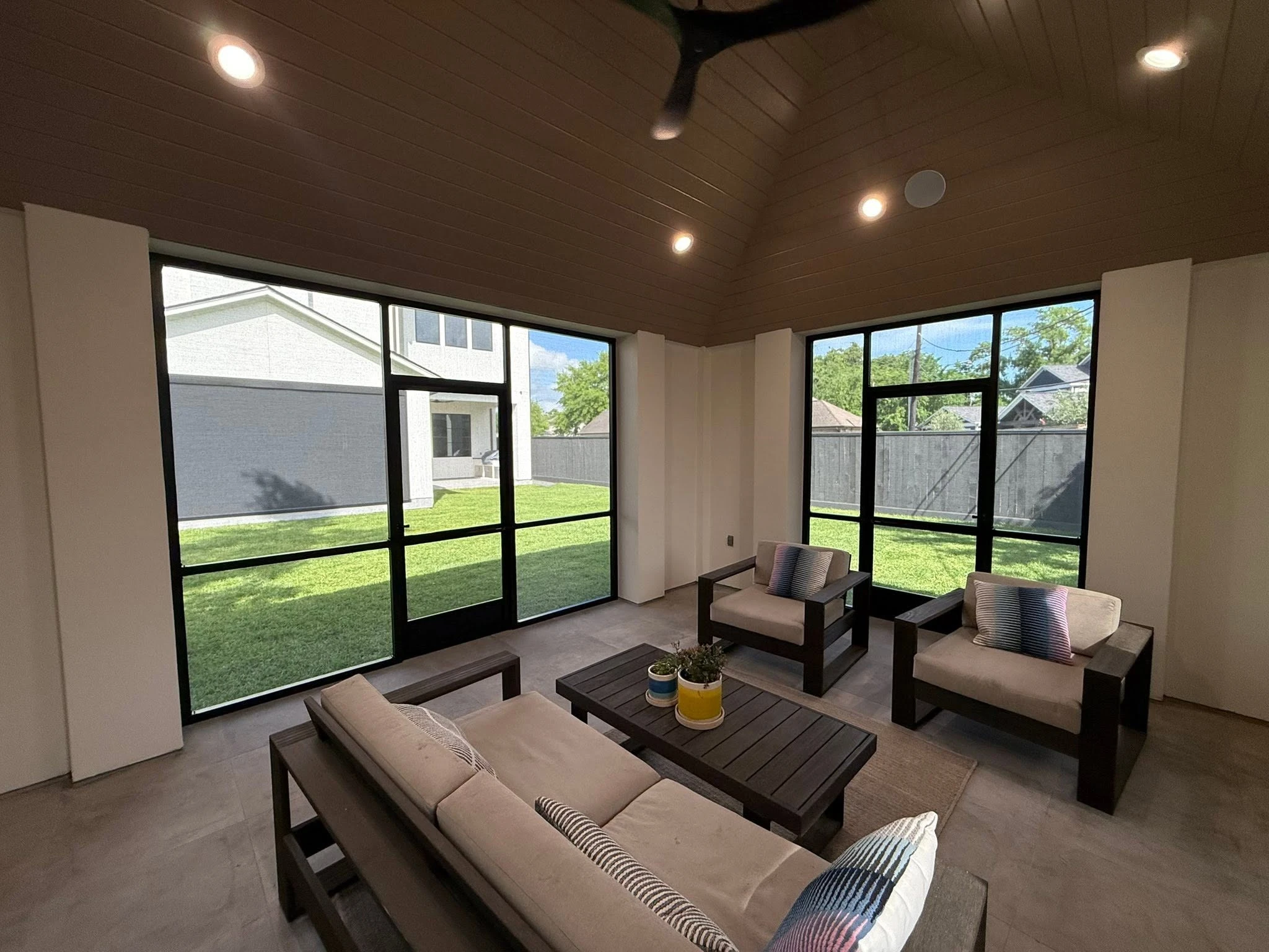 Fixed patio enclosure wall with a screen door
