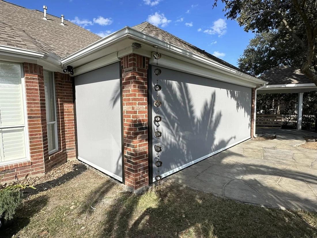 Patio enclosed with motorized screens for bug protection
