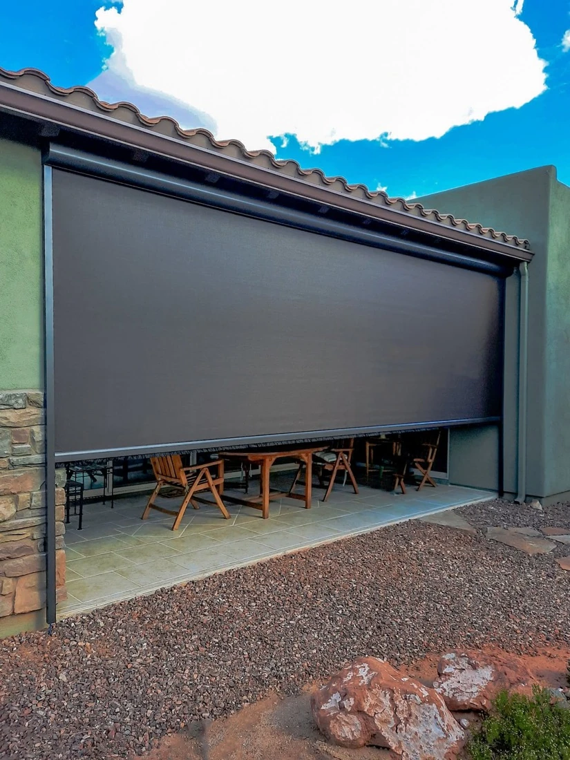 Custom motorized screen enclosing a covered patio