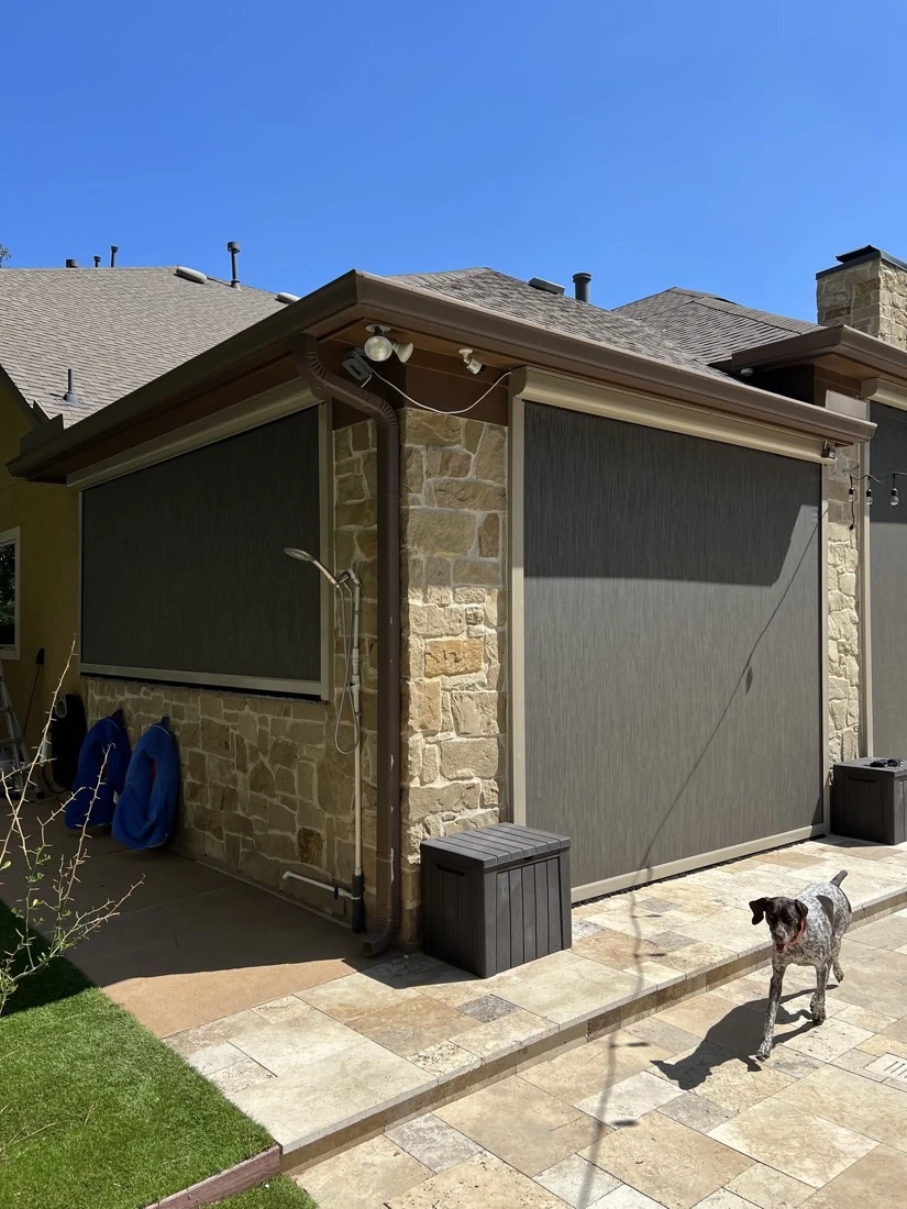 Motorized screens blocking sun and bugs on a backyard patio