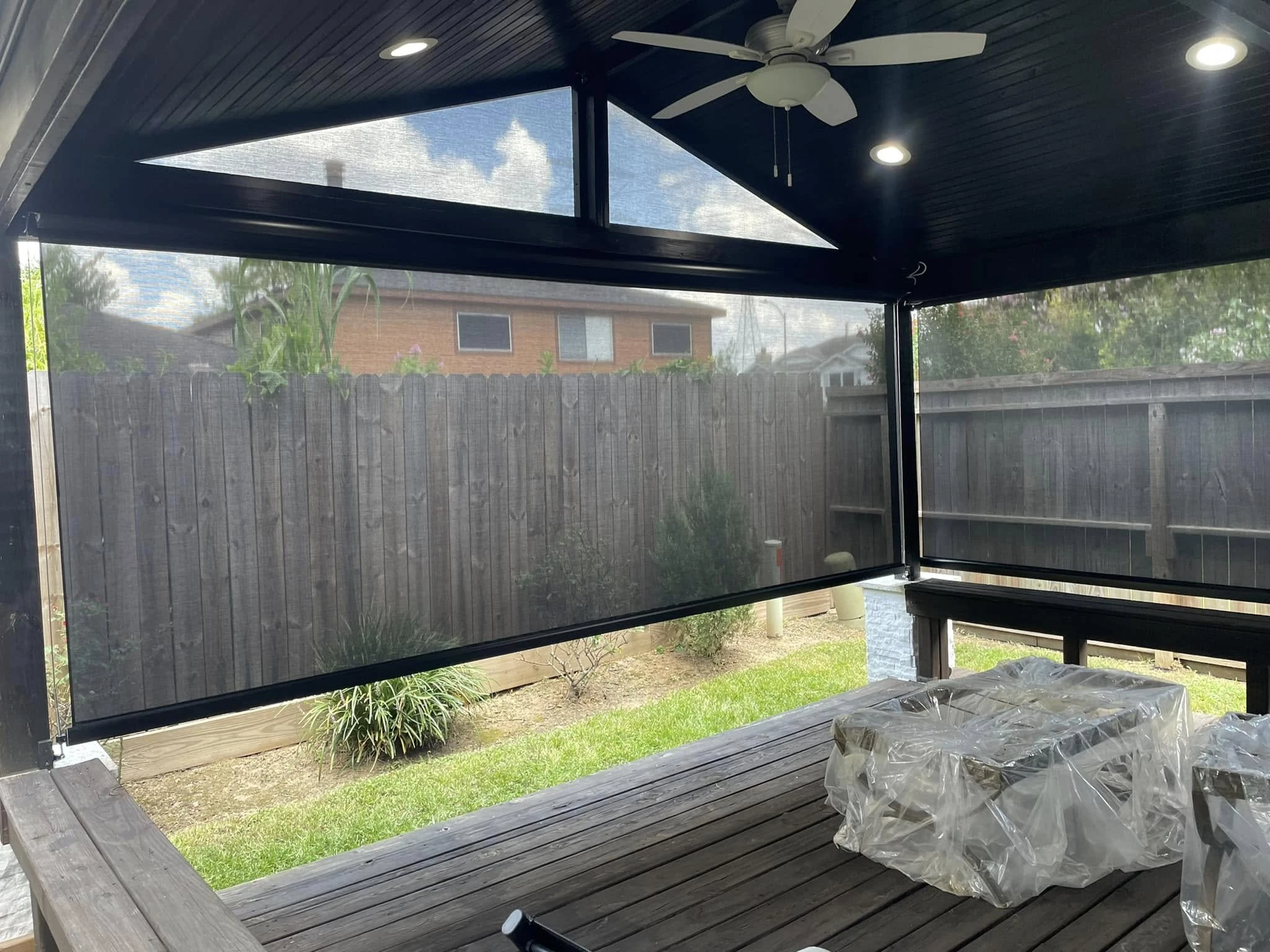 Roller patio shade blocking afternoon sun on a Texas patio
