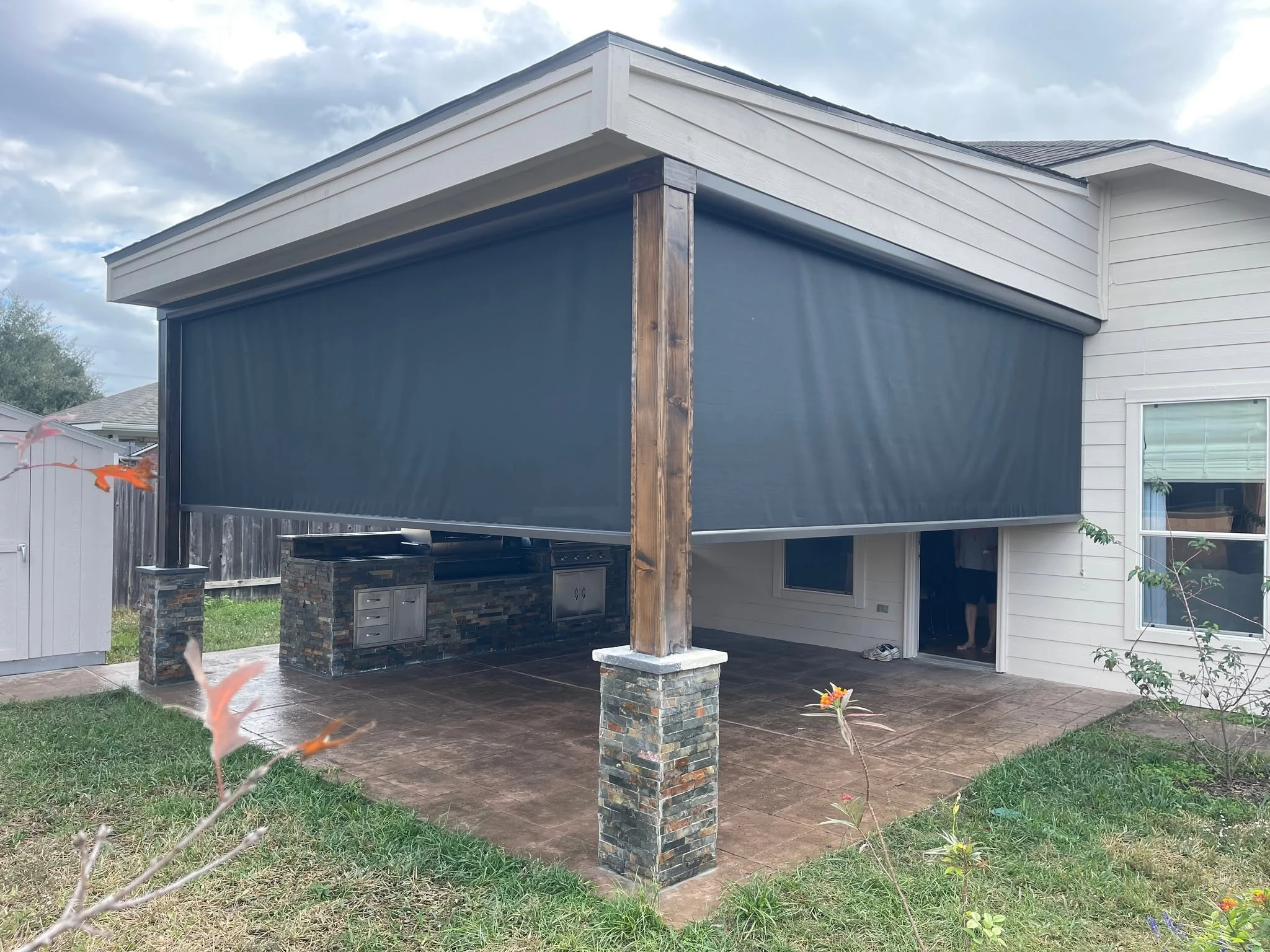 Open roller patio shade installed on a Houston home