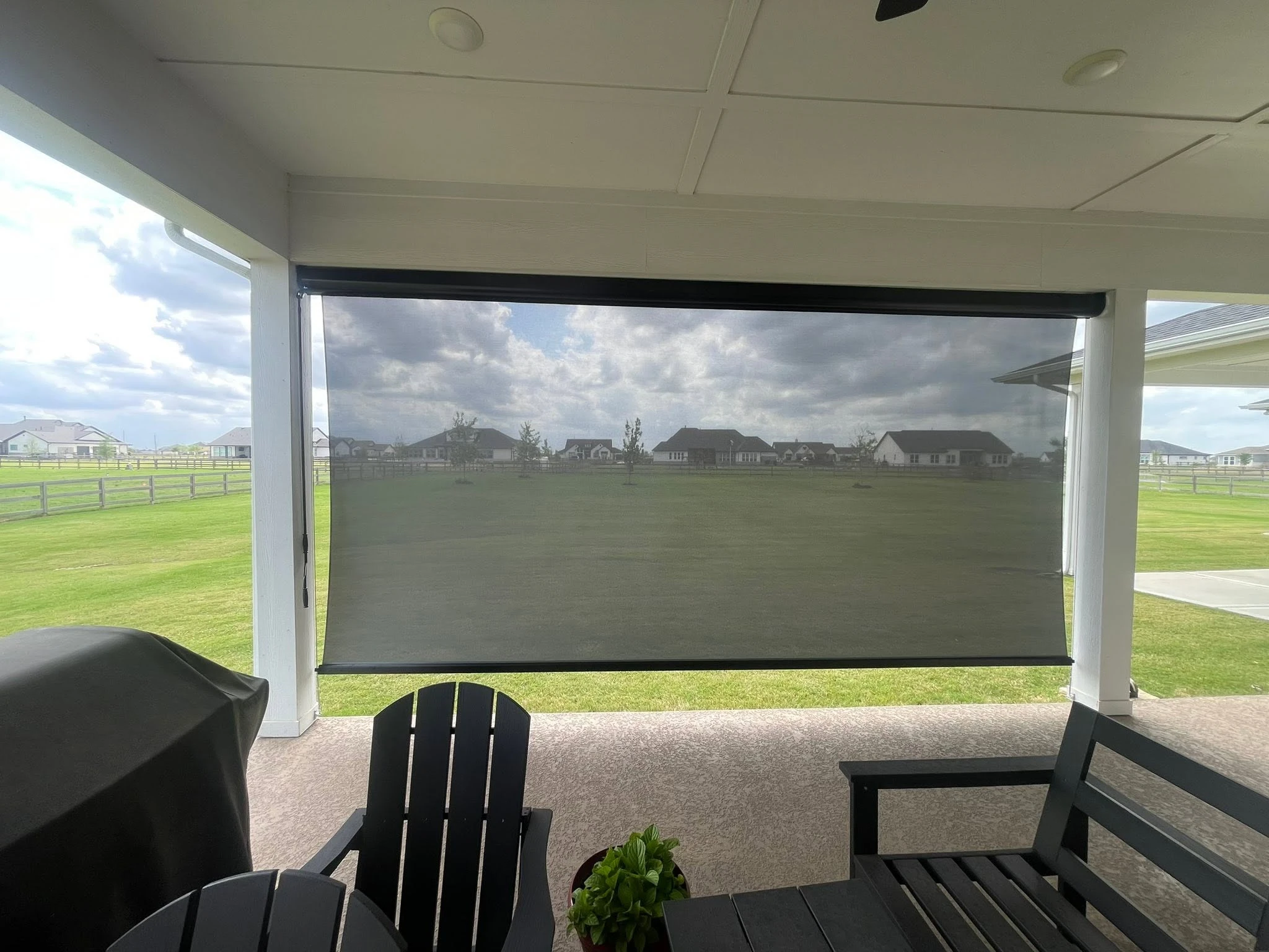 Open roller patio shade providing solar protection