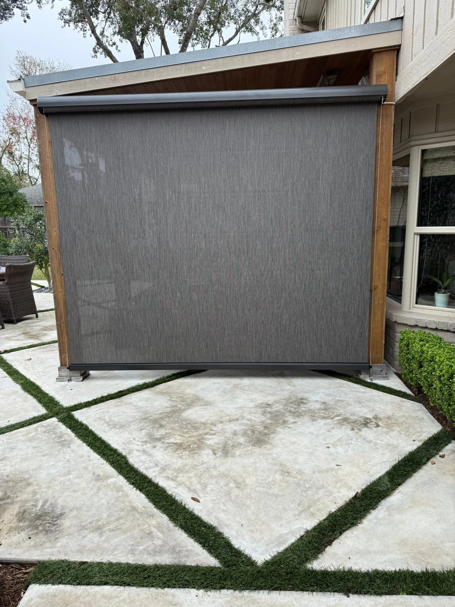 Roll-up solar shade on a covered Houston patio